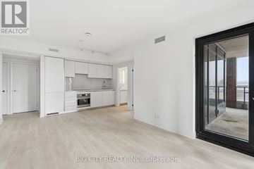 Toronto (Thorncliffe Park) condo for rent - A spacious kitchen with white cabinets and a large window.