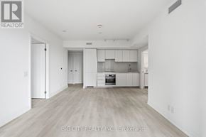 Toronto (Thorncliffe Park) condo for rent - A spacious kitchen with white cabinets and a wooden floor.