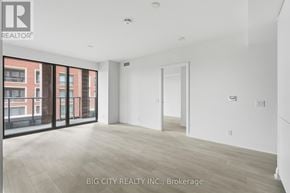 Toronto (Thorncliffe Park) condo for rent - A spacious room with a view of a brick building outside the window.