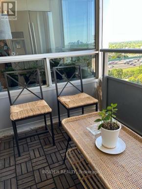 Toronto (Bayview Village) condo for rent - A balcony with a table, two chairs and a potted plant.