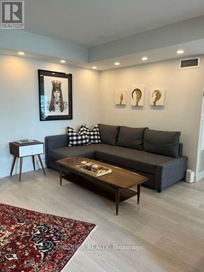 Toronto (Bayview Village) condo for rent - A living room with a grey couch, a coffee table, and a rug.