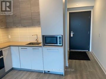 Markham (Commerce Valley) condo for rent - A kitchen with a microwave and a sink.