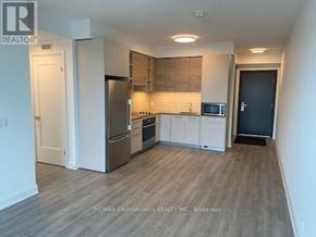 Markham (Commerce Valley) condo for rent - A kitchen with a refrigerator, oven, and microwave.