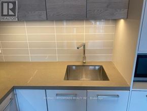 Markham (Commerce Valley) condo for rent - A kitchen with a sink and a brokerage sign.