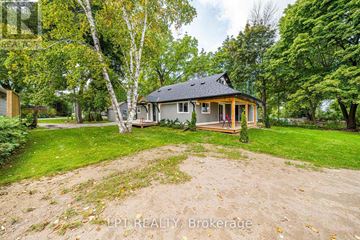 Georgina (Historic Lakeshore Communities) apartment for rent - A house with a yard and trees in the background.