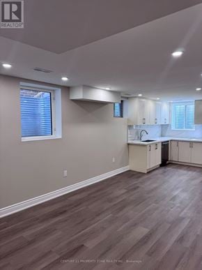 Caledon apartment for rent - A well-lit kitchen with wooden flooring and white cabinets.