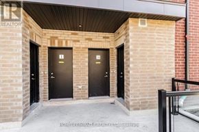 Mississauga (Erin Mills) townhouse for rent - A real estate sign is displayed on a building entrance.