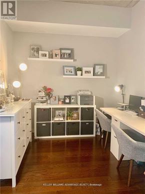 Toronto (Waterfront Communities) condo for rent - A room with a desk, drawers, and shelves with pictures and plants.