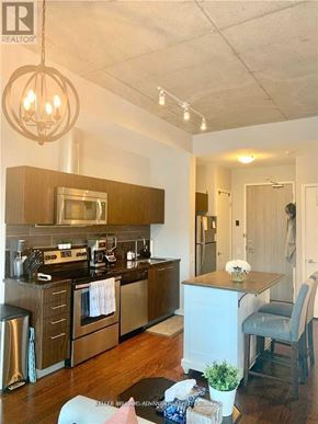 Toronto (Waterfront Communities) condo for rent - A kitchen with a stove top oven and a refrigerator.