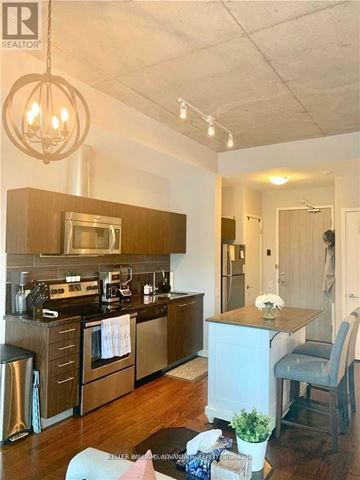 Toronto (Waterfront Communities) condo for rent - A kitchen with a stove top oven and a refrigerator.