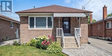 Toronto (Maple Leaf) apartment for rent - A house with a black door and a small front yard.