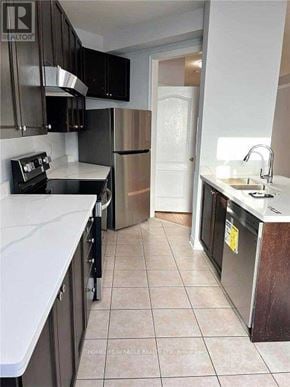 Mississauga (Hurontario) apartment for rent - A kitchen with black cabinets and a white counter top.