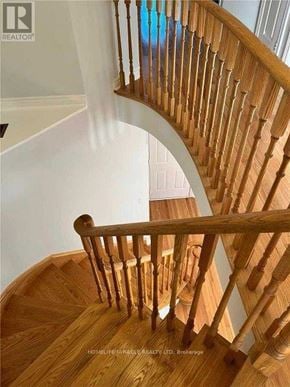 Mississauga (Hurontario) apartment for rent - A wooden staircase with a handrail.