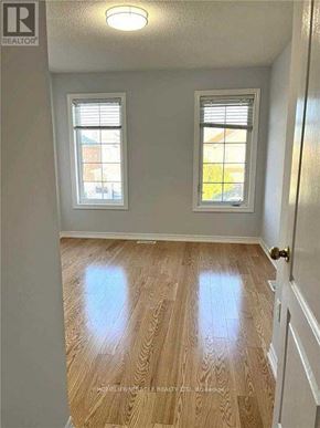 Mississauga (Hurontario) apartment for rent - A room with wooden floors and two windows.