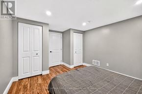 Hamilton (Hampton Heights) apartment for rent - A bedroom with a bed, two doors, and a window.