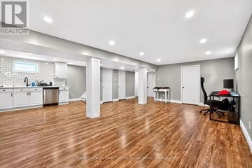 Hamilton (Hampton Heights) apartment for rent - A spacious kitchen and living room with wooden flooring and white walls.
