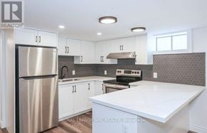 St. Catharines (Carlton/Bunting) apartment for rent - A kitchen with a stainless steel refrigerator and white countertops.