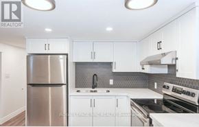 St. Catharines (Carlton/Bunting) apartment for rent - A modern kitchen with white cabinets and stainless steel appliances.