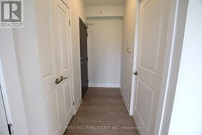 Toronto (Mount Pleasant West) condo for rent - A hallway with white doors and a black door on the left.