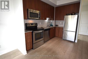 Toronto (Mount Pleasant West) condo for rent - A kitchen with wooden cabinets and stainless steel appliances.