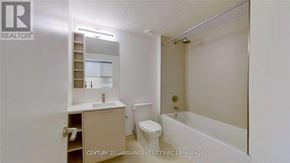 Toronto (Niagara) condo for rent - A white bathroom with a toilet, sink, and bathtub.