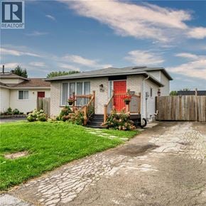 London apartment for rent - A house with a red door and a stone pathway leading to it.