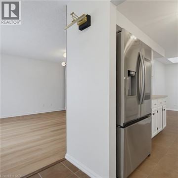 London apartment for rent - A modern kitchen with a stainless steel refrigerator and wooden flooring.