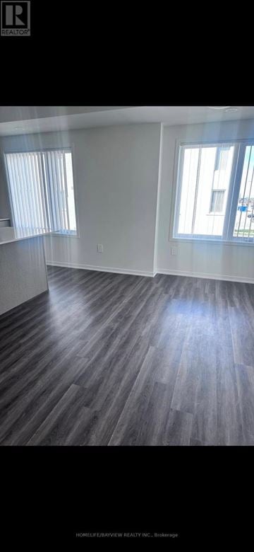 Vaughan (Vaughan Corporate Centre) townhouse for rent - A room with wooden flooring and a window.