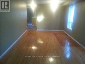 Brampton (Northwest Sandalwood Parkway) apartment for rent - A room with wooden flooring and a window on the right side.