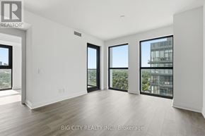 Toronto (Thorncliffe Park) condo for rent - A spacious room with a view of the city through large windows.