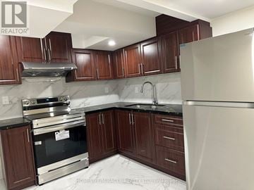 Brampton (Fletcher's West) apartment for rent - A kitchen with dark wood cabinets and stainless steel appliances.