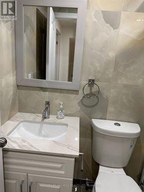 Brampton (Fletcher's West) apartment for rent - A white toilet is in a bathroom with a marble counter top.