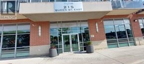Brampton (Queen Street Corridor) condo for rent - The front of a building with a sign that says "215 Queen St. East".