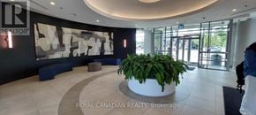 Brampton (Queen Street Corridor) condo for rent - A reception area with a large plant in the middle.