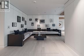 Toronto (Mount Pleasant West) condo for rent - A modern living room with a white wall and a black couch.