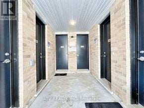 Richmond Hill (Mill Pond) townhouse for rent - A hallway with doors on both sides and a sign that says "REALTOR".