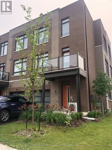 Vaughan (Vaughan Grove) townhouse for rent - A modern brick apartment building with a balcony and a tree in front.