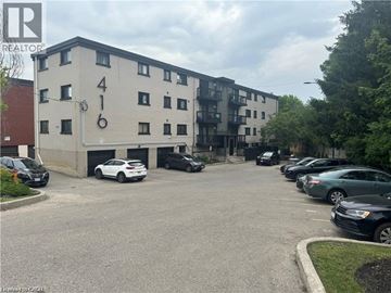 Kitchener apartment for rent - A parking lot in front of a building with the number 416 on it.
