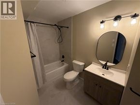 Kitchener apartment for rent - A bathroom with a toilet, sink, and shower.
