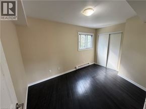Kitchener apartment for rent - A room with a window and sliding door.