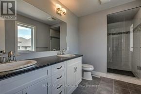 Woodstock (Woodstock - North) apartment for rent - A bathroom with a sink, mirror, toilet, and shower.