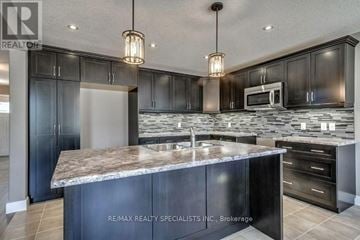 Woodstock (Woodstock - North) apartment for rent - A modern kitchen with dark cabinets and a marble countertop.