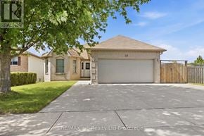 Woodstock (Woodstock - South) duplex for rent - A house with a brown roof and a white garage door is for sale.
