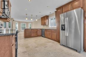 Woodstock (Woodstock - South) duplex for rent - A modern kitchen with a stainless steel refrigerator and wooden cabinets.