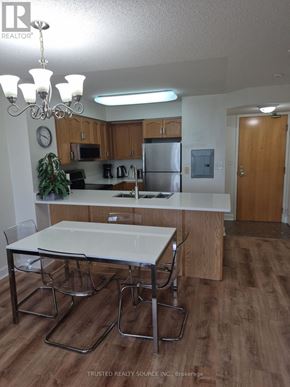 Toronto (Yonge-Eglinton) condo for rent - A kitchen with a table and chairs in the foreground.