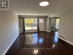 Toronto (Agincourt North) apartment for rent - A room with wooden floors and a sliding glass door leading to a balcony.