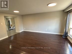 Toronto (Agincourt North) apartment for rent - A spacious room with wooden flooring and a large mirror on the wall.