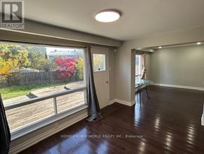 Toronto (Agincourt North) apartment for rent - A room with a large window overlooking a deck with trees.