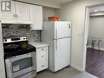 Toronto (Agincourt North) apartment for rent - A kitchen with a white refrigerator and stove top oven.