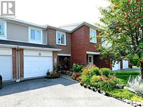 Ottawa townhouse for rent - A house with a white garage door and a driveway.